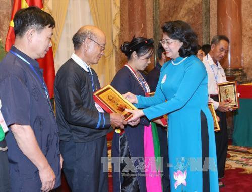 国家副主席邓氏玉盛向少数民族先进模范代表人士赠送礼物。越通社记者 伊晋 摄