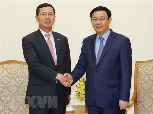 越南政府副总理王廷惠（右）会见韩国新韩金融集团董事长兼总经理林勇正。图自越通社
