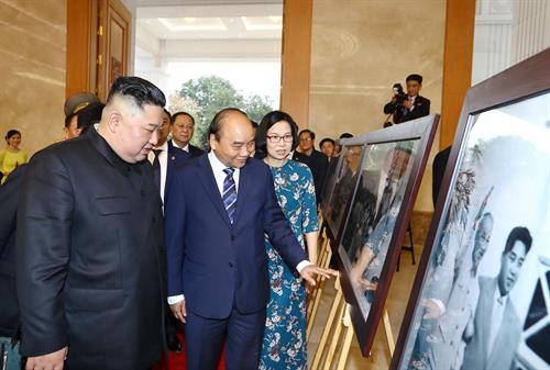 两位领导一起参观由越南通讯社提供的“越南—朝鲜关系”展示区。图自越通社