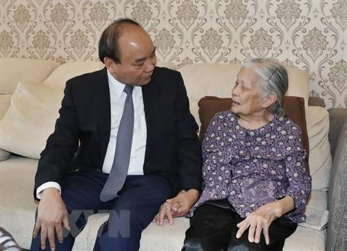 阮春福向郑廷魁烈士母亲致以亲切慰问。（图片来源：越通社）