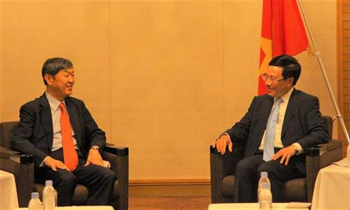 越南政府副总理兼外交部长范平明会见日本国籍协力机构主席北风伸一。图自越通社