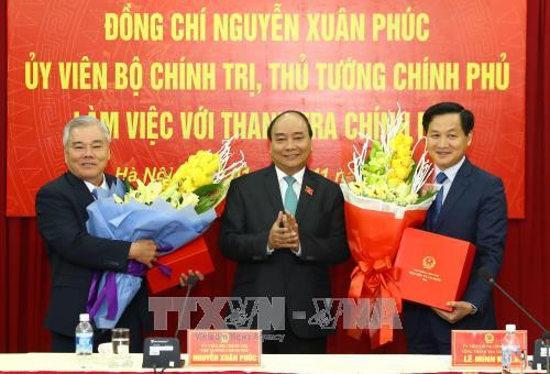 阮春福向新任政府监察总署总监察长黎明慨（右）和朔庄省省委书记潘文六（左）赠送鲜花。（越通社—VNA）