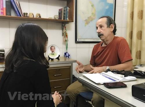 古巴拉美社记者佩雷斯·阿尔伯托·萨拉查（右）接受记者采访。图自越通社