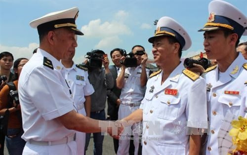 越南海军司令部代表何春处大校（右）迎接中国海军少将、东海舰队副司令沈浩。（图片来源：越通社）