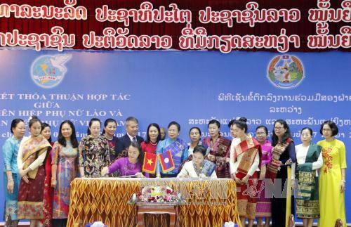 越南妇联主席与老挝妇联主席签署双方合作协议(2017-2022年阶段)。(图片来源L越通社) 越南妇联主席与老挝妇联主席签署双方合作协议(2017-2022年阶段)。(图片来源L越通社)