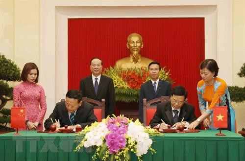 武文赏与黄坤明见证两国出版社的签署仪式。（图片来源：越通社）