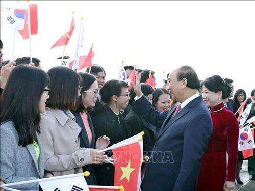 阮春福和夫人抵达首尔机场。图自越通社