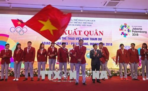 越南文化体育旅游部部长阮玉善向代表团团长移交了旗帜。（图片来源：越通社）