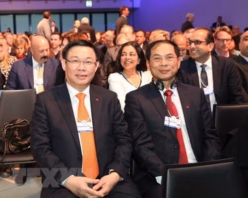 王廷惠（左）与外交部常务副部长裴青山出席第48届世界经济论坛年会全体会议开幕式。越通社记者 黄花 摄