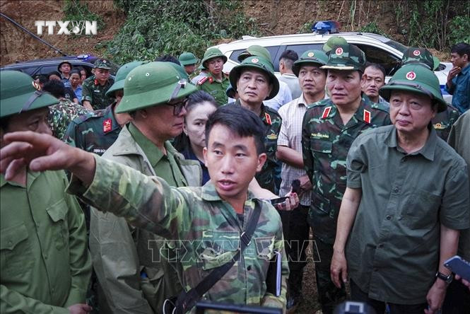 村长莫阿诗在奠边省车容乡杭普喜村山体滑坡和洪水现场向政府副总理陈红河汇报。图自越通社 vna-potal-dien-bien-khan-truong-hoan-thien-thu-tuc-khen-thuong-truong-ban-mua-a-thi-stand.jpg