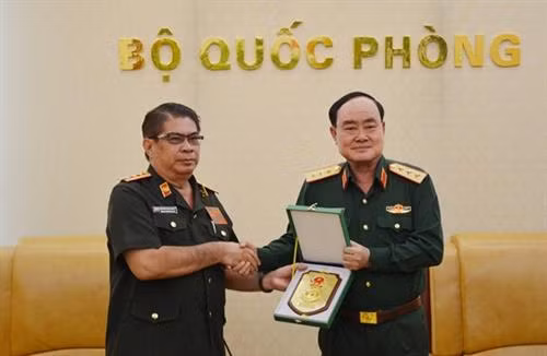 越南国防部副部长陈单上将向老挝人民军计划财务局副局长西萨万赠送纪念品。(图片来源:人民军报) 越南国防部副部长陈单上将向老挝人民军计划财务局副局长西萨万赠送纪念品。(图片来源:人民军报)
