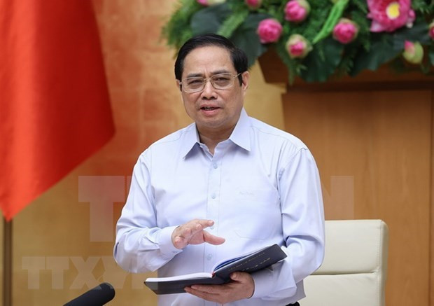 越南政府总理范明政发表讲话。图自越通社 越南政府总理发动特殊竞赛运动 全国团结携手 同心协力防控并战胜疫情 ảnh 1