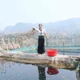 山罗省巴麻坡轻乡（现芒敦乡）框村（Khoang）妇女分会主任梁氏寸女士（泰族）照料鱼苗