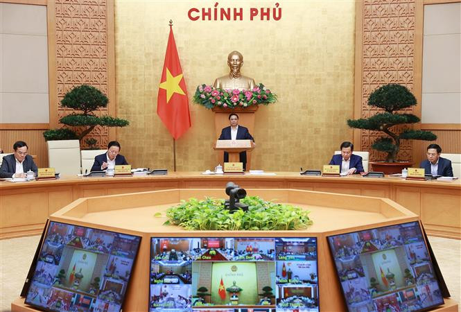 政府与各地方视频会议和政府3月份例行会议开幕 政府总理范明政主持会议。图自越通社 政府与各地方视频会议和政府3月份例行会议开幕 政府总理范明政主持会议 ảnh 1