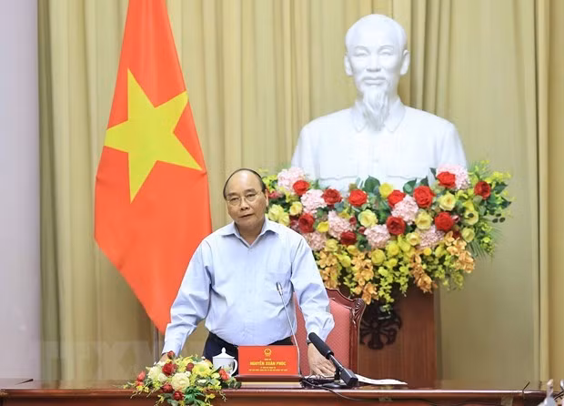国家主席阮春福: 纺织服装业是疫情后助推经济复苏的拳头产业 ảnh 1